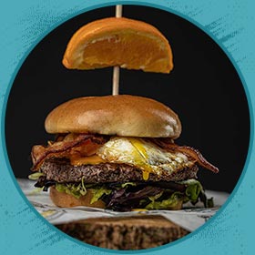 Burger with bacon, fried egg, lettuce, and a bun—perfect with our shakes or craft beer.