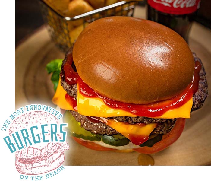 A cheeseburger with ketchup, lettuce, pickles, and tomato from Gulf Coast Burger Company.