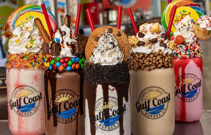 Indulge at Gulf Coast Burger Company: Five extravagant milkshakes with candy and colorful toppings.